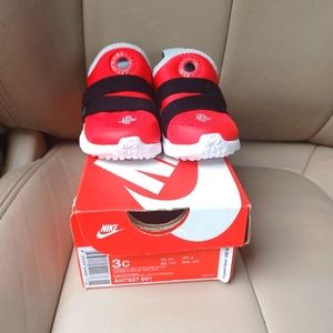 Red, black and white nike sneaker